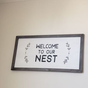 "Welcome to Our Nest" sign